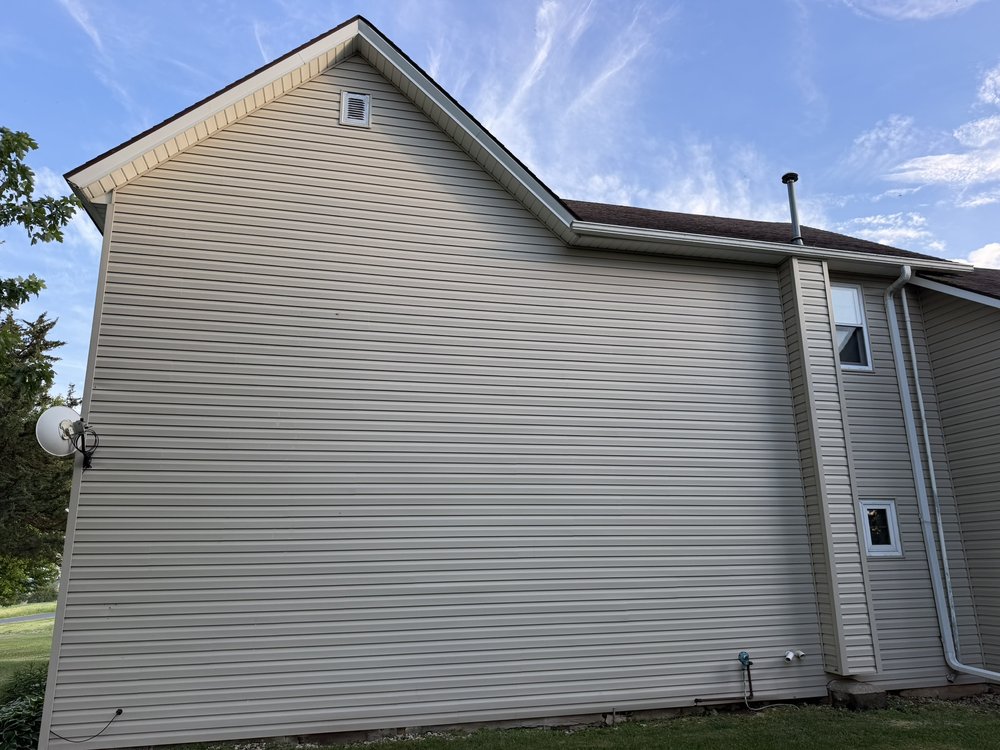 Clean house siding after professional soft washing